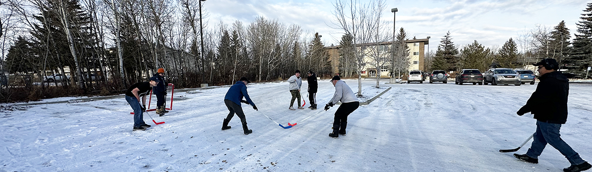 Staff and Students playing outdoor hockey